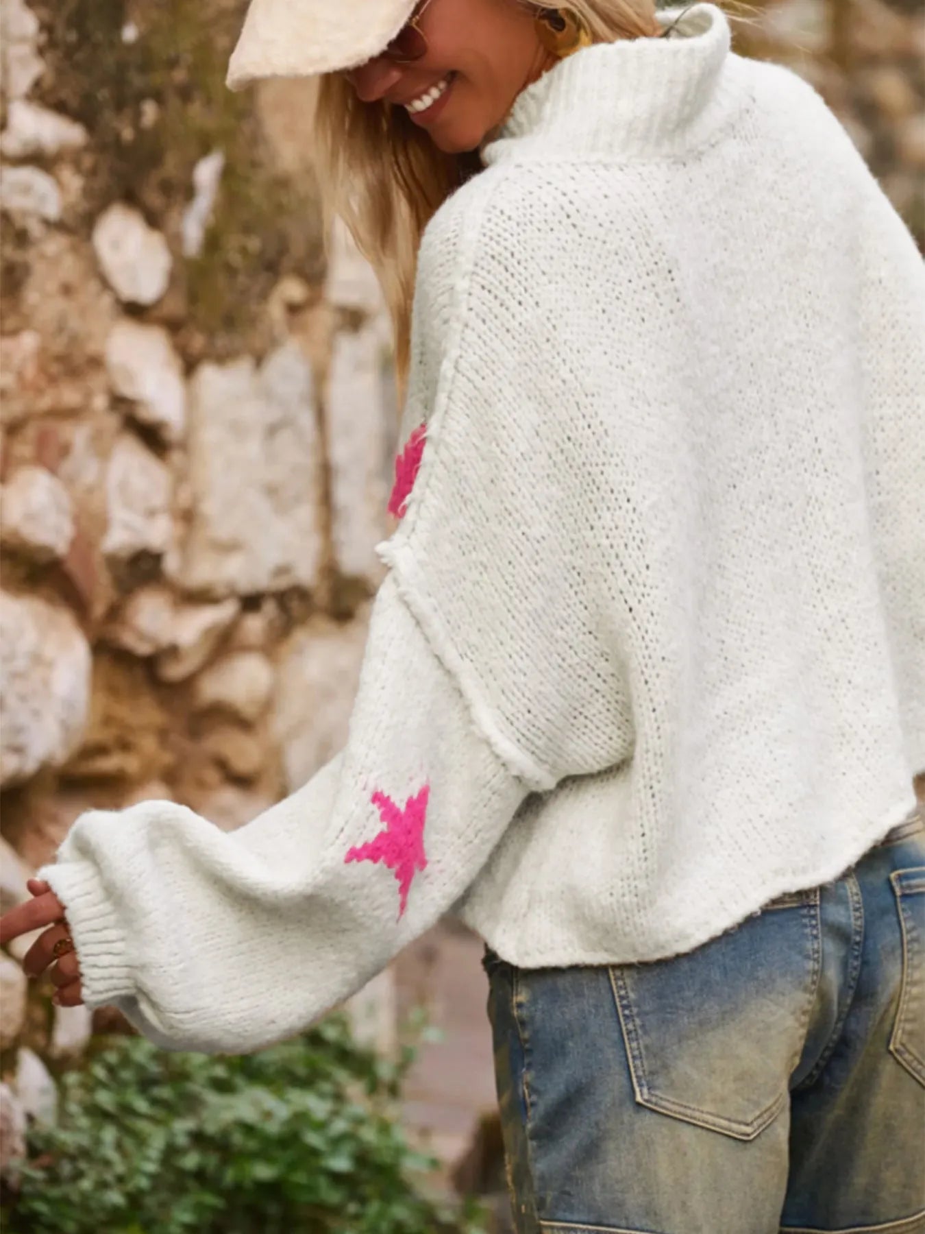 White women's loose fit turtleneck pullover with five-pointed star pattern detail