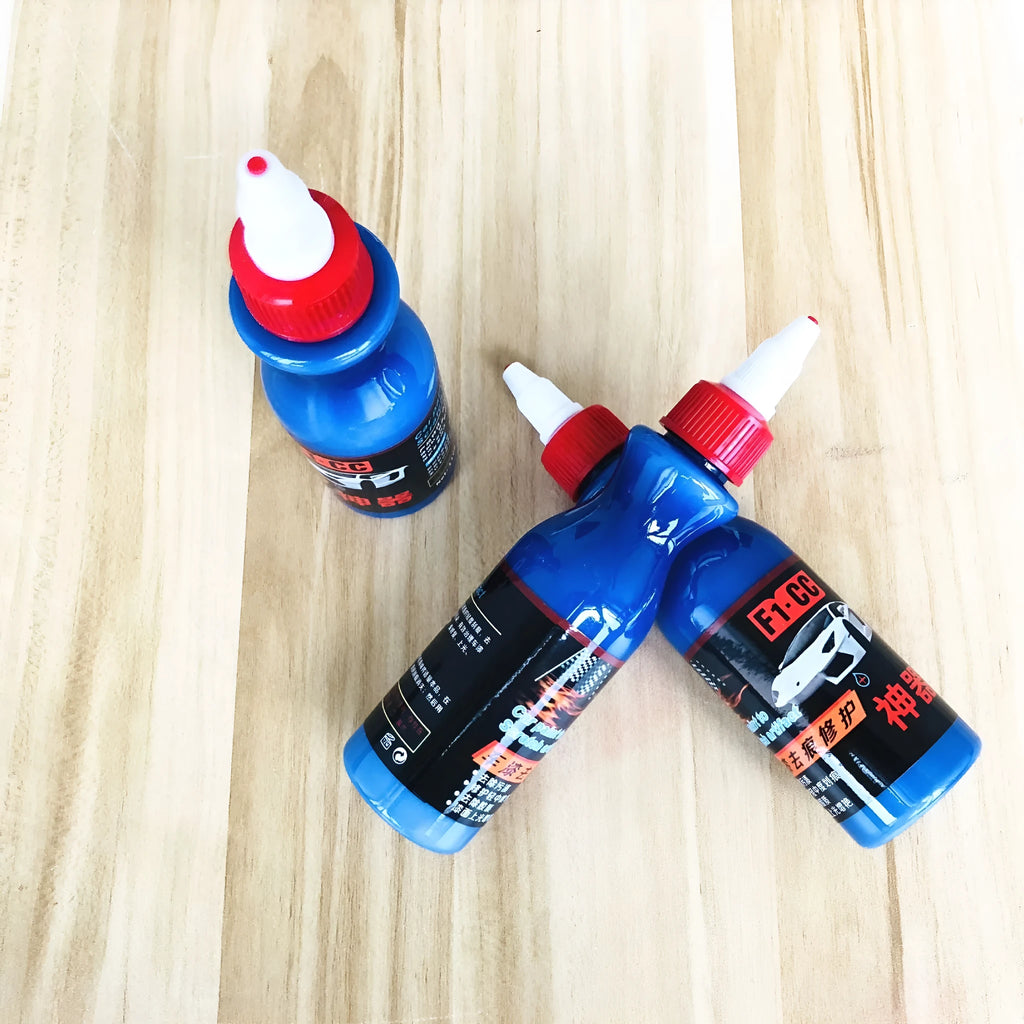 Small blue automotive scratch repair agent bottle with wiping tool for car paint scratch removal