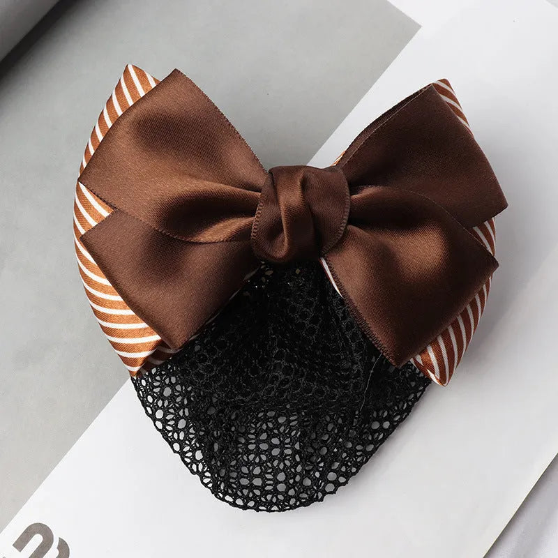 Professional hair clip with a black net pocket and a red flower bow ornament on a white background.