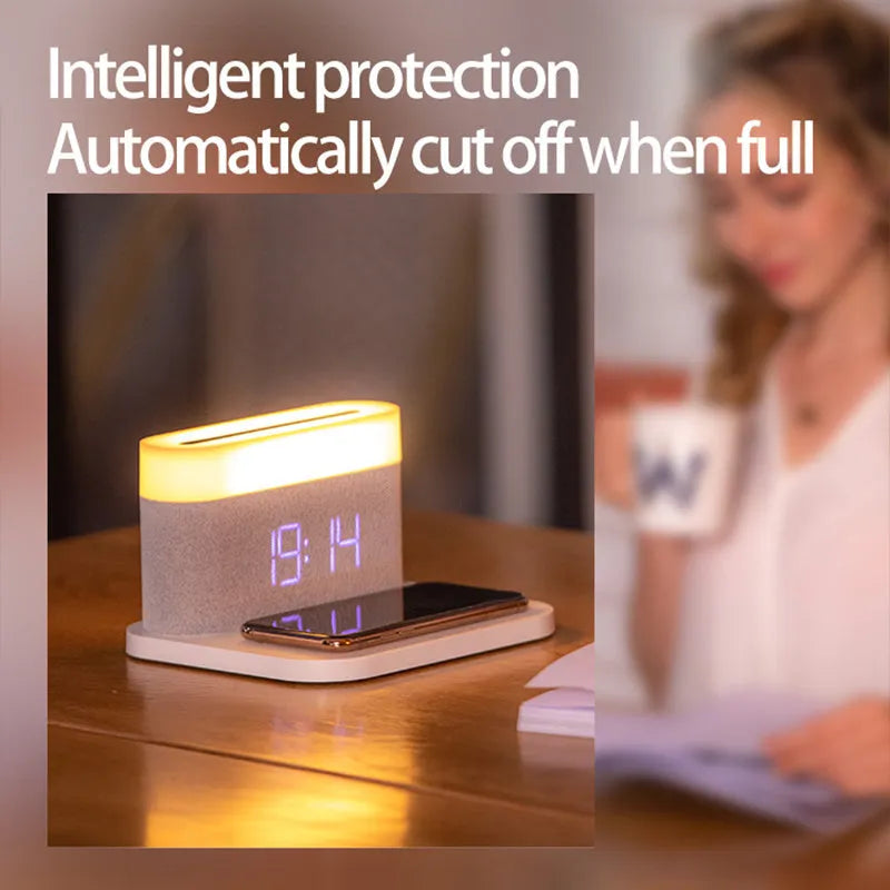 White wireless charging desktop clock with LED display and foldable stand on a wooden desk.
