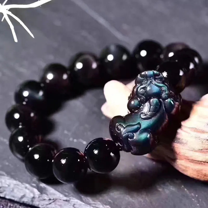 Natural ice colour obsidian crystal bracelet showing pale stone beads on wrist