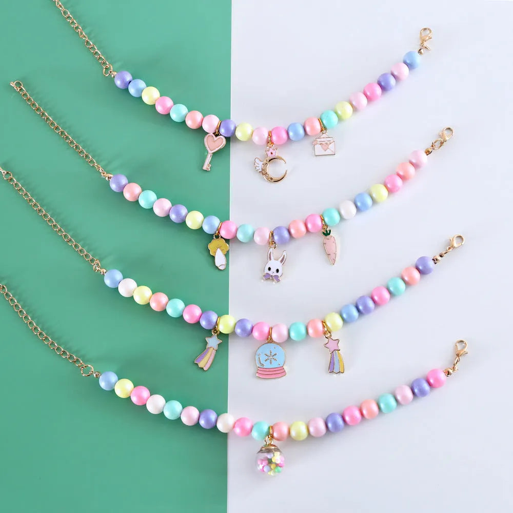 Colourful resin pet jewellery with moon and meteor motifs in macaron colours for dogs and cats