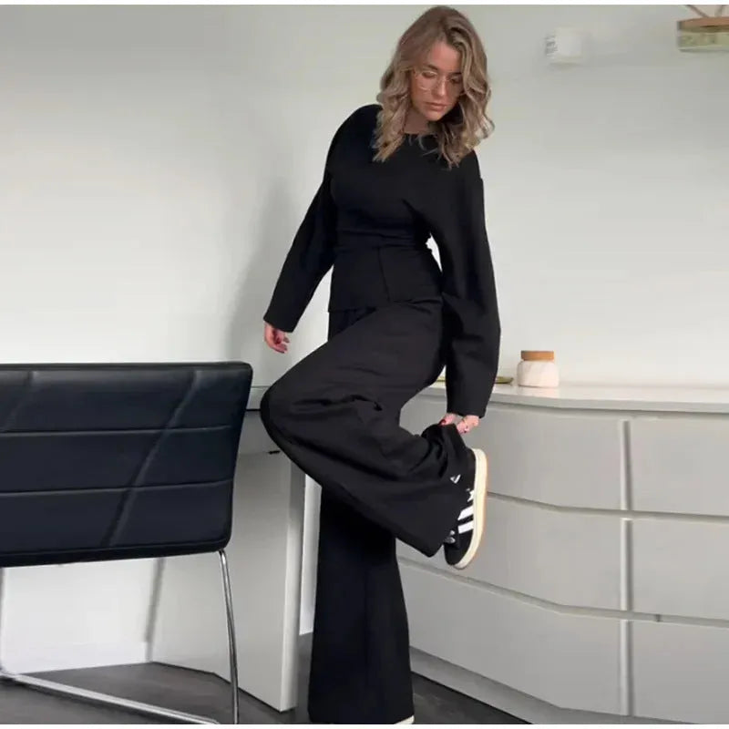 Women's apricot polar fleece suit set with long sleeve top and wide leg trousers on a hanger.
