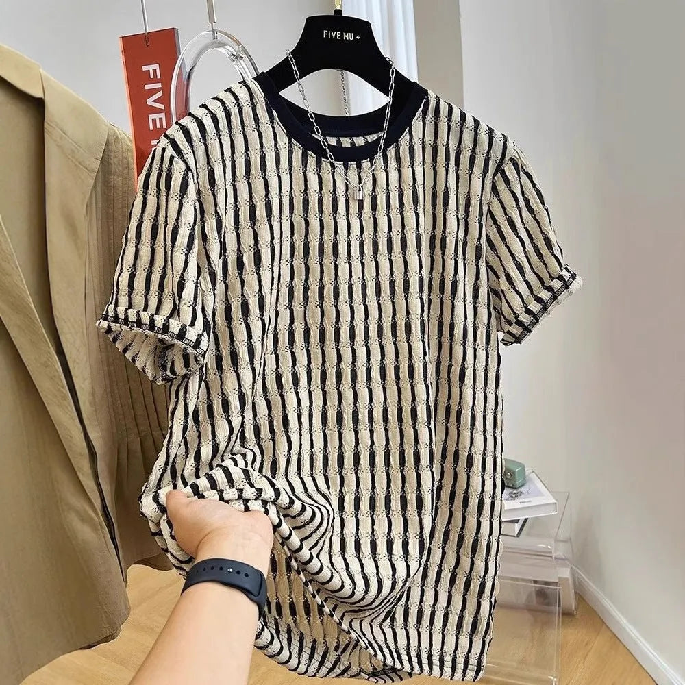A man's loose-fitting black and white striped casual pullover shirt made from linen and silk.