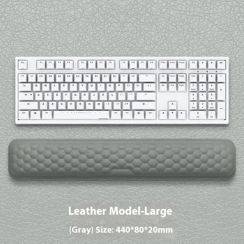 Customisable memory foam mouse wrist pad with black cloth cover on a desk.