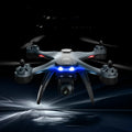 GPS quadrocopter with dual cameras and remote controller showing plastic construction and protective blade covers