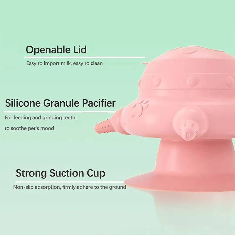 Pink silicone pet milk feeder with four nursing pacifiers and a lid on a flat base.