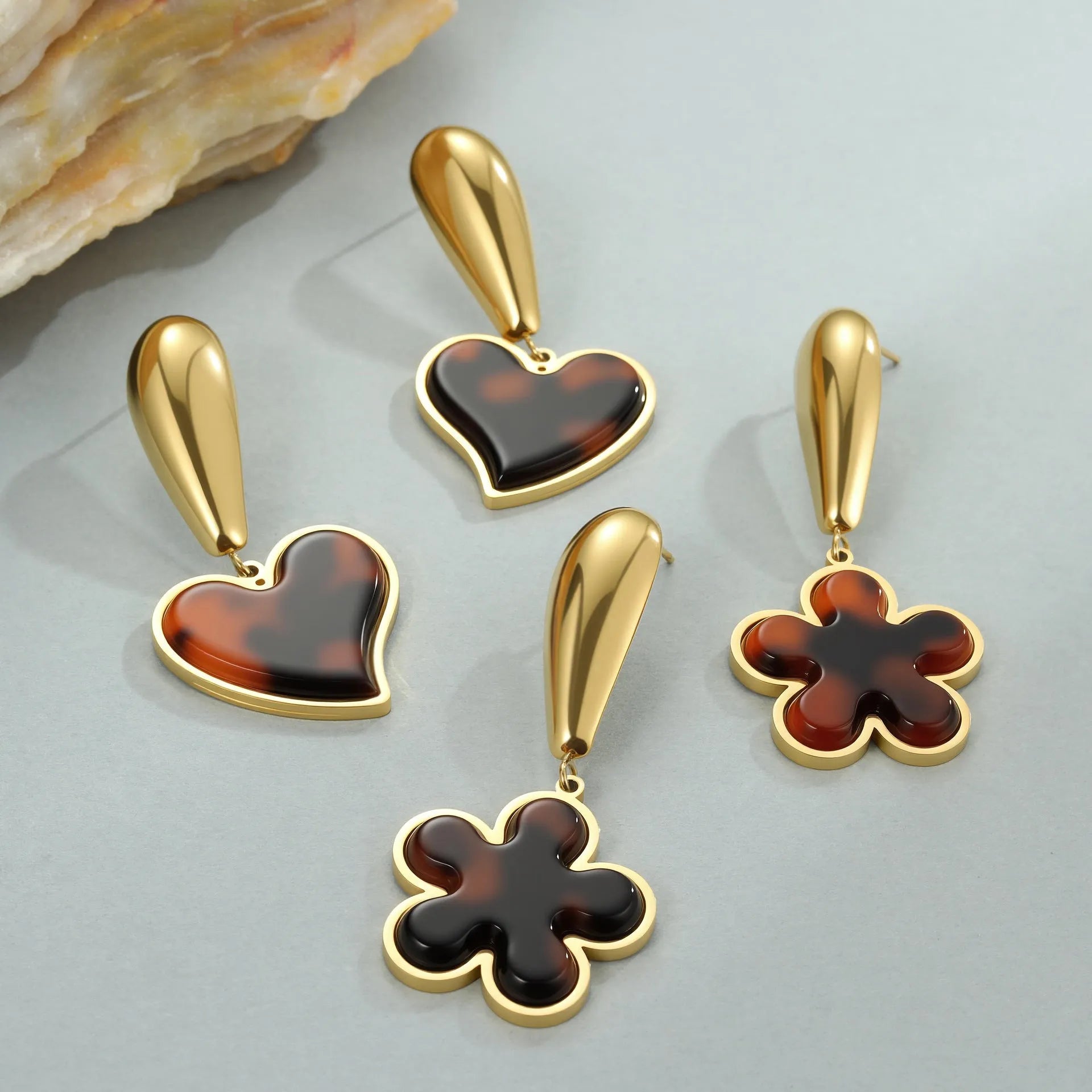 Tortoiseshell resin hawksbill colour earrings with 18K gold electroplating, showing heart-shaped and flower geometric designs