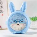 Cartoon children's alarm clock with night light in blue and pink colours
