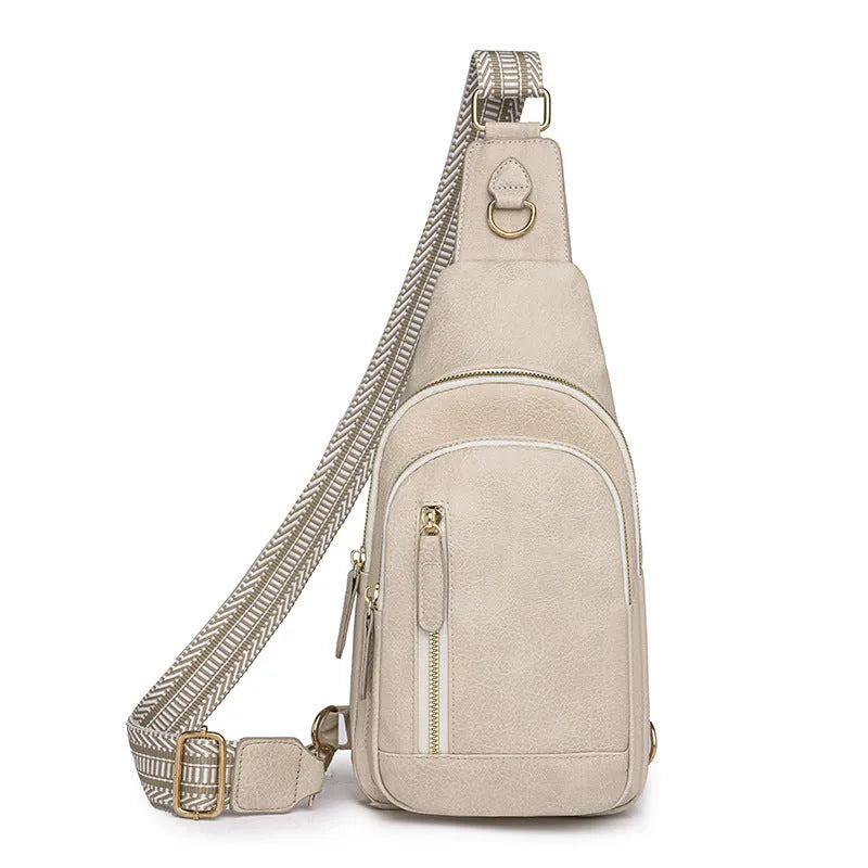 Women's small brown PU leather chest bag with open front pocket worn across chest
