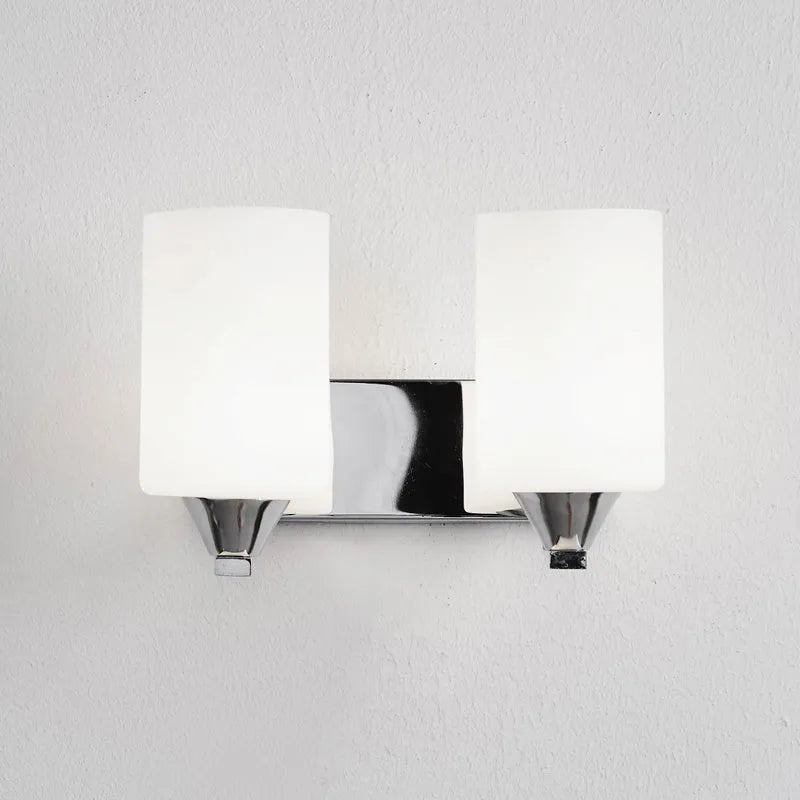 Modern chrome-finished wall lamp with a clear glass shade, shown in a single head configuration.