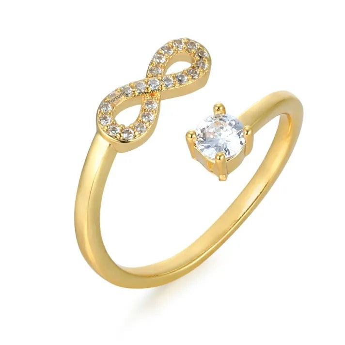 Geometric open metal ring with zircon stones displaying a single letter, available in gold, rose gold, and silver finishes.