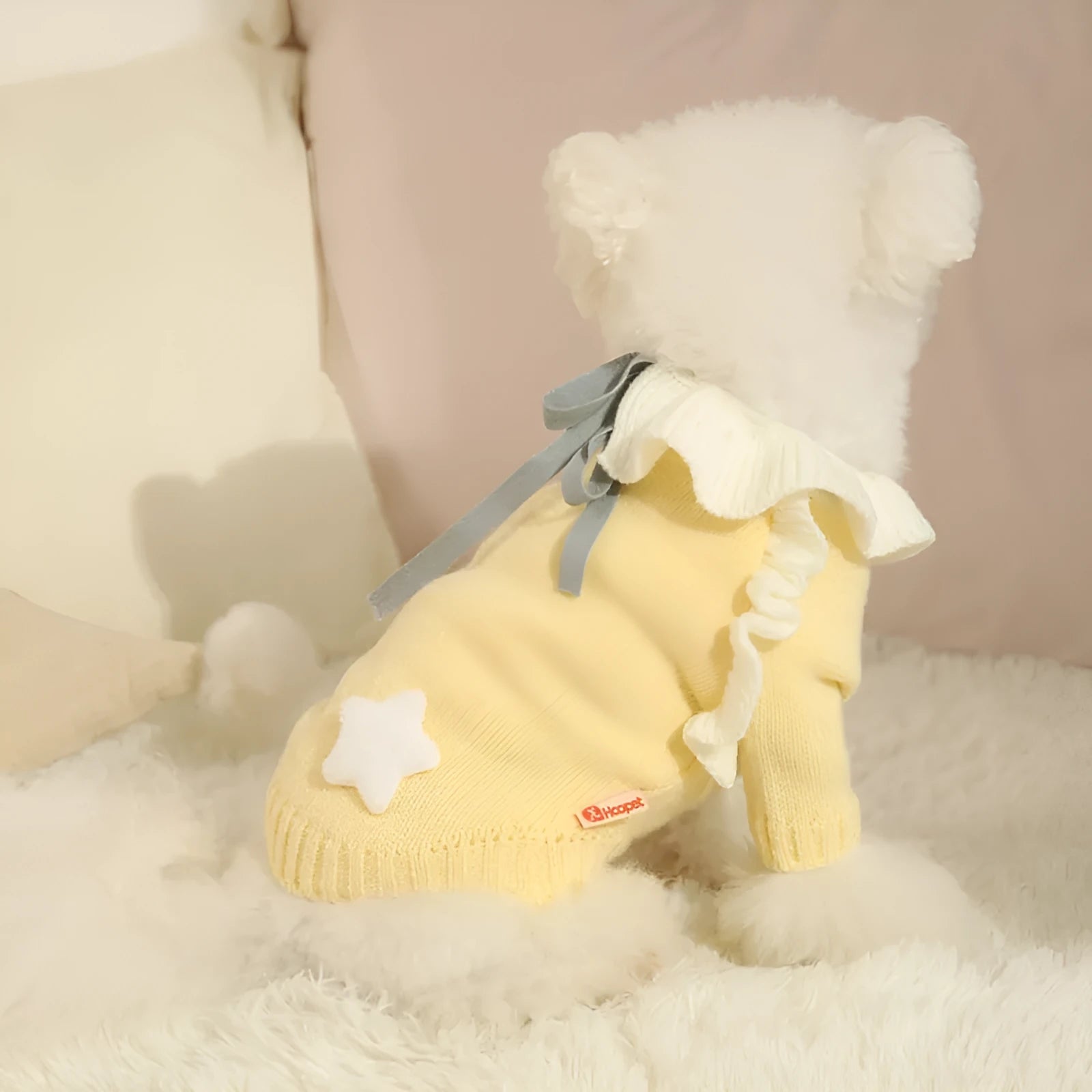 Yellow acrylic dog sweater shown on small breed pet with chest measurement guide