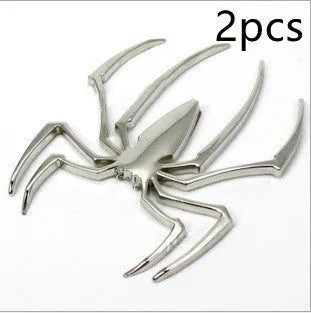 Three-dimensional metal spider sticker in gold colour, measuring 7cm by 5cm.
