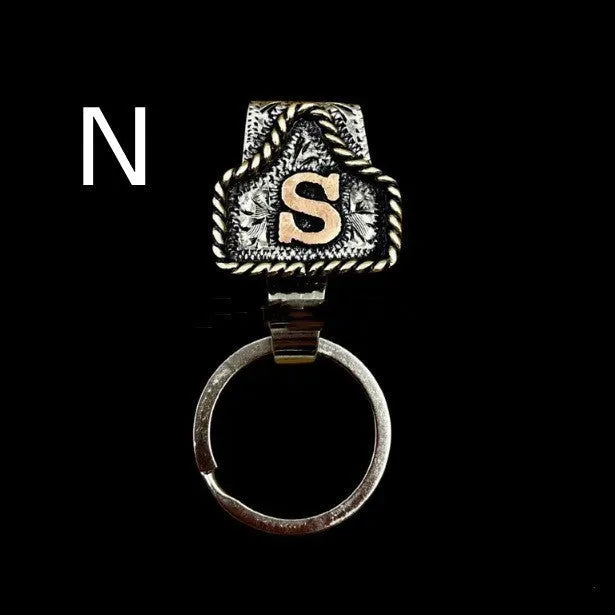 Handmade metal cow tag key holder for belts in assorted colours on a leather strap