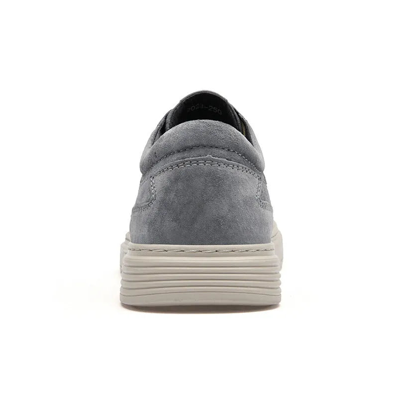 Men's grey low-top pigskin leather skate shoes with flat rubber sole and lace-up front.