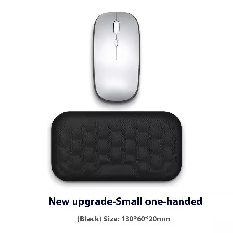 Customisable memory foam mouse wrist pad with black cloth cover on a desk.