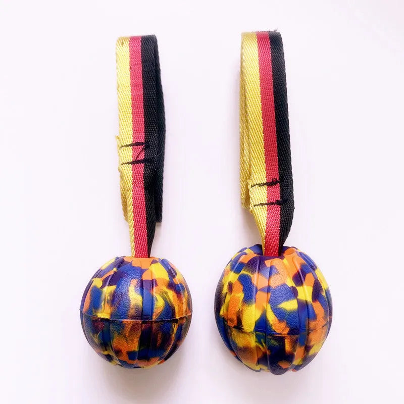 EVA floating pet tetherball toy in yellow and camouflage colours with string attachment