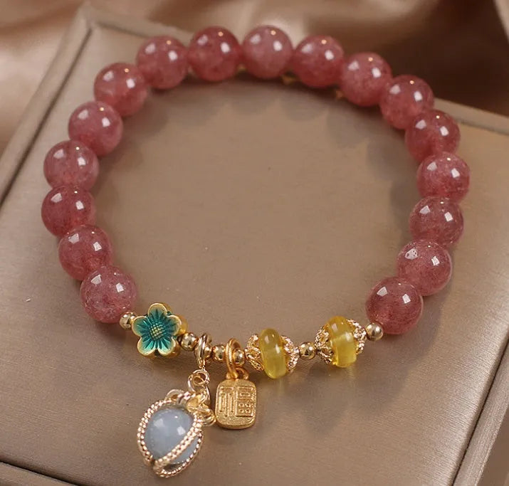 Red women's beaded bracelet with natural strawberry quartz stones and sparkling rhinestone accents.