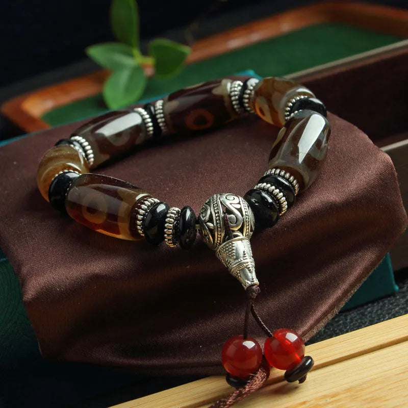 Agate Tibetan dzi bead bracelet with three-eye design and polished finish