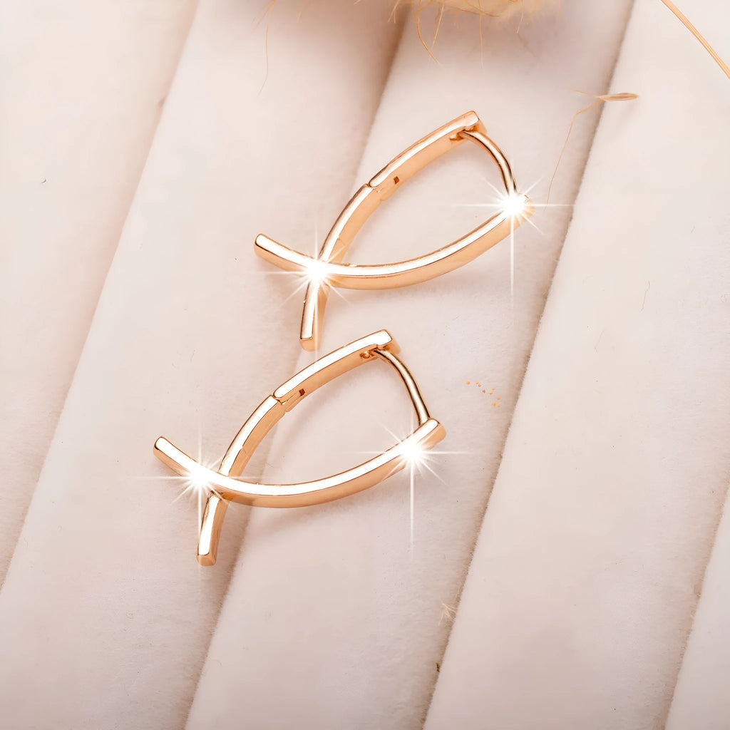 A pair of rose gold cross shaped fashion earrings on a copper alloy base.