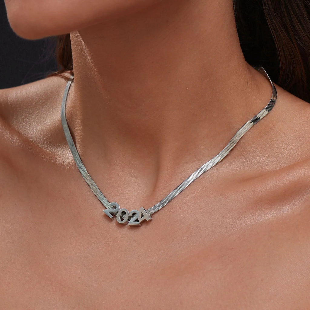 Titanium steel necklace with a single charm showing a number or letter on a 40.5cm gold or silver chain.