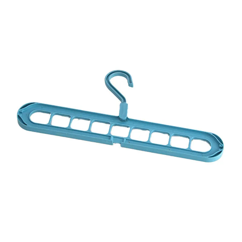 Green plastic nine-hole folding pant hanger for trousers and skirts.