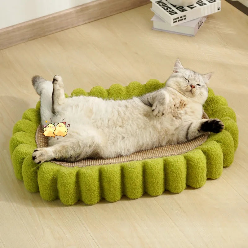 Green oval cardboard cat scratching pad with sisal surface, serving as a cat bed.