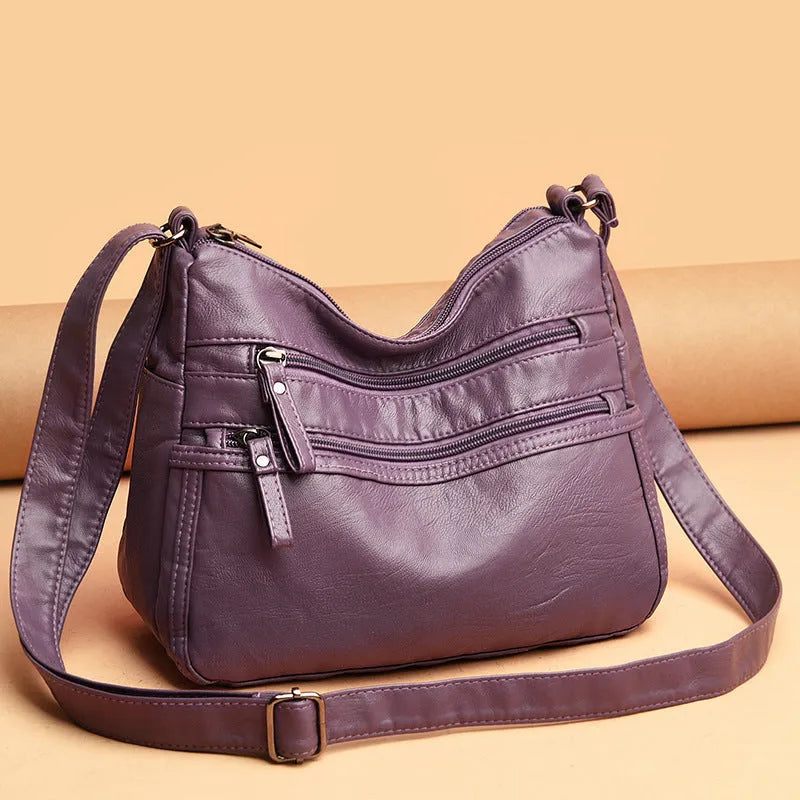 Women's washed leather crossbody bag in solid colour, retro messenger style with adjustable strap and soft handle