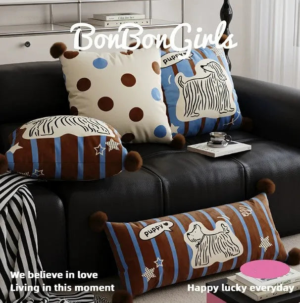 Blue cartoon animal printed cushion on a grey sofa showing removable cover.