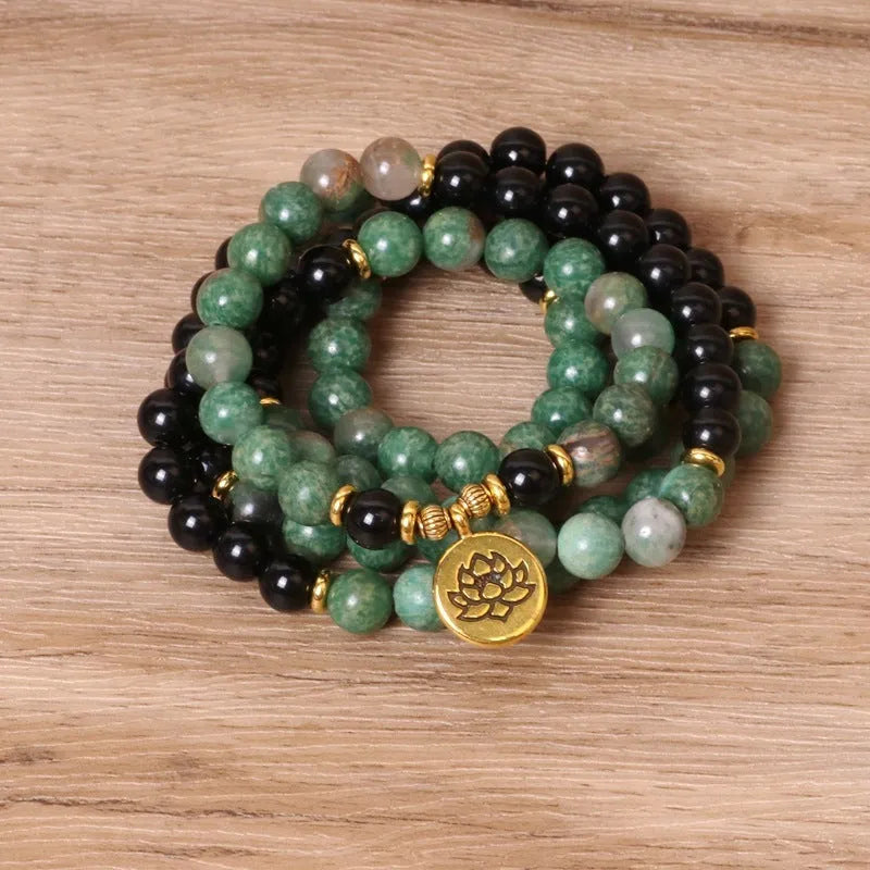 Green and black elastic beaded bracelet with alloy metal construction and natural style design