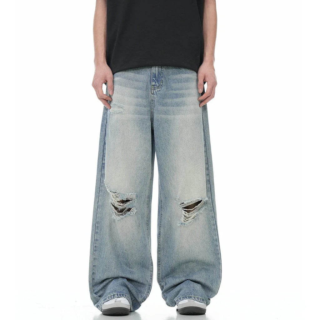 Men's blue straight-leg jeans with ripped details and zipper fly in retro style