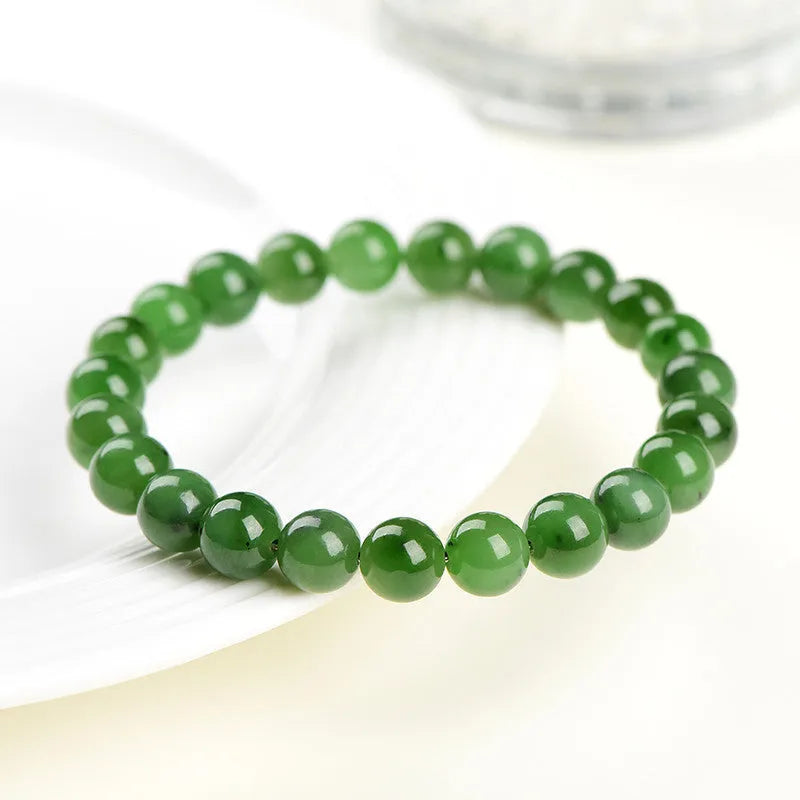 Natural Hetian jade bead bracelet in jasper colours, showing polished beads on a wrist.