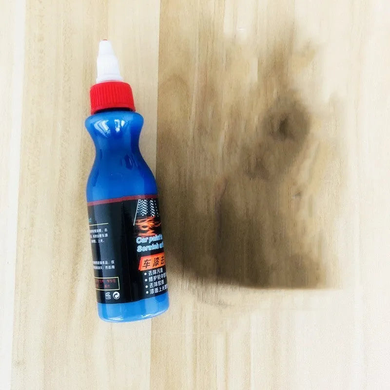 Small blue automotive scratch repair agent bottle with wiping tool for car paint scratch removal