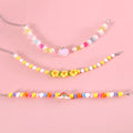 Colourful plastic bead cat necklace adjustable for pet wear in rainbow, peach, or small flower patterns