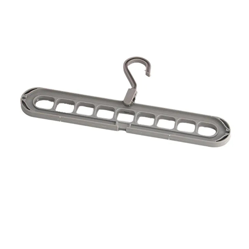 Green plastic nine-hole folding pant hanger for trousers and skirts.