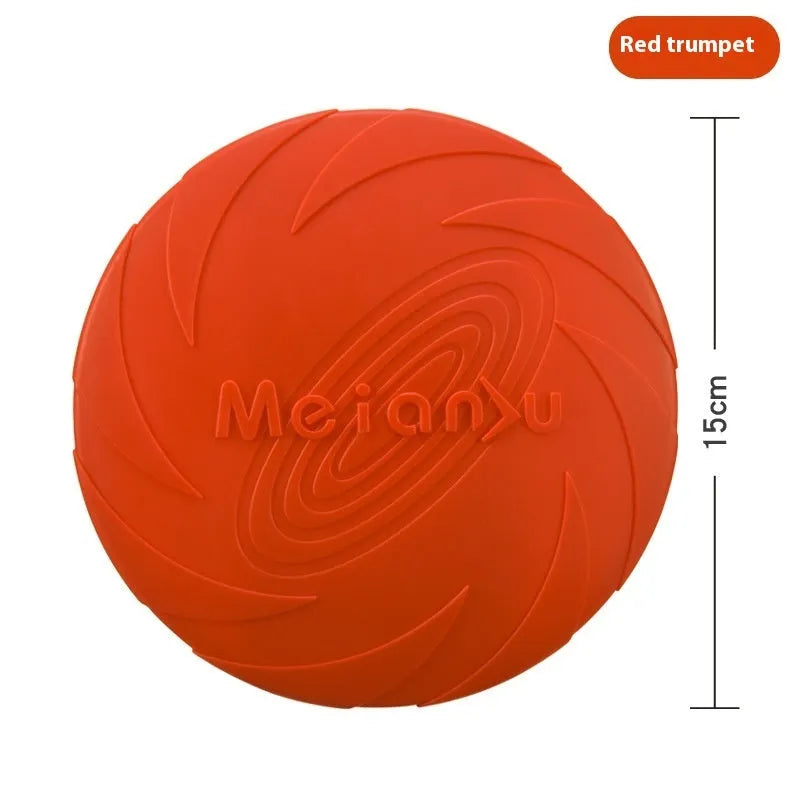 Soft rubber dog frisbee toy in blue, shown on grass for scale.