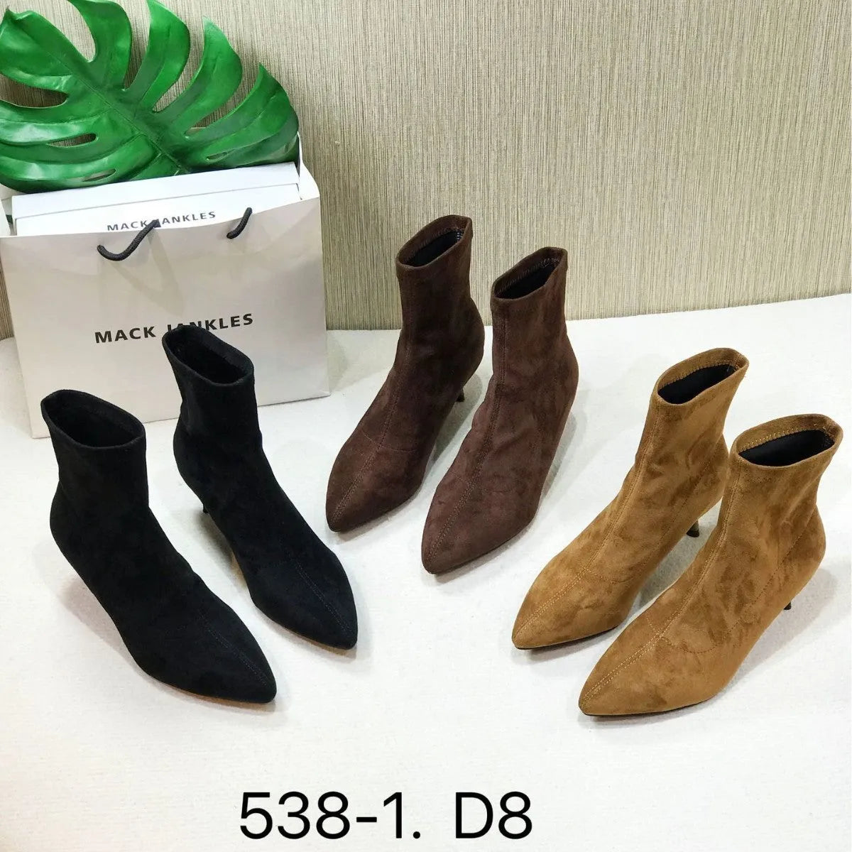 Women's black pointed toe ankle boots with a stiletto heel and mid-calf sock length.