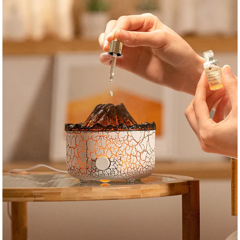 Volcano humidifier with LED lights and mist creating a fiery flame effect, column-shaped plastic body on a table