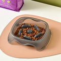 Blue plastic dog slow feeder bowl with anti-choking ridge design for puppies and dogs.