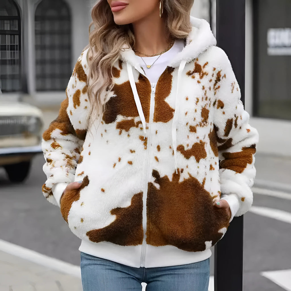Yellow brown cow print hooded cardigan jacket with front zipper on a model.
