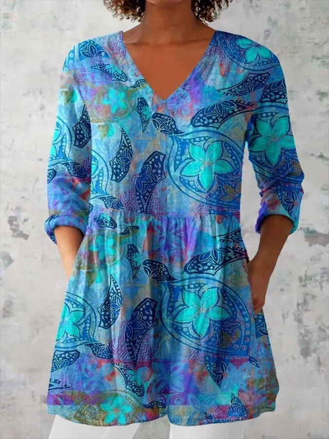 Woman wearing a retro slim fit, digitally printed long-sleeved top in a floral design.