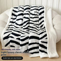 Double-layer leopard jacquard taffeta blanket in camel zebra pattern on a single bed.