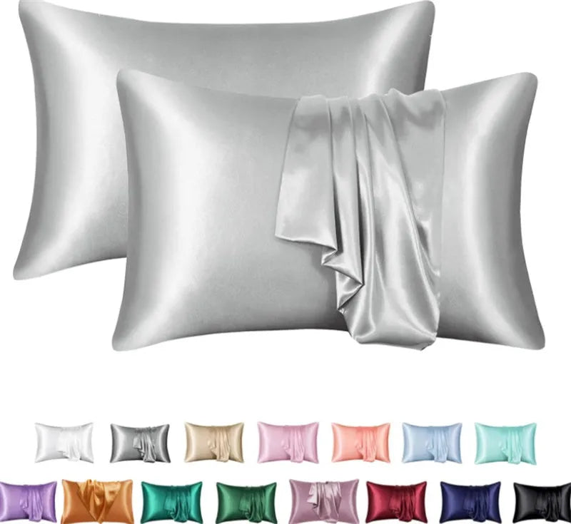 Dark blue polyester satin pillowcase with envelope closure on a bed with white sheets