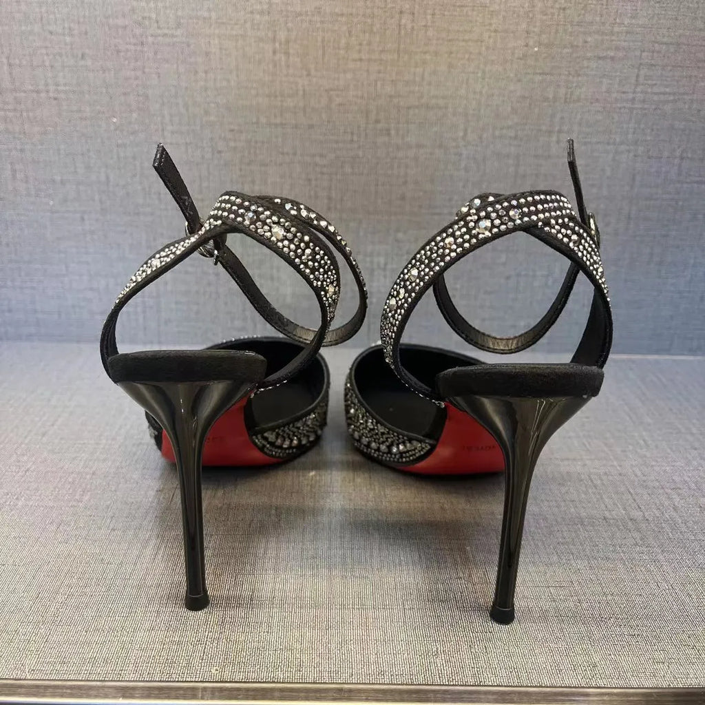 Women's silver high heel shoe with hollow stiletto heel, pointed toe, and bright red sole.
