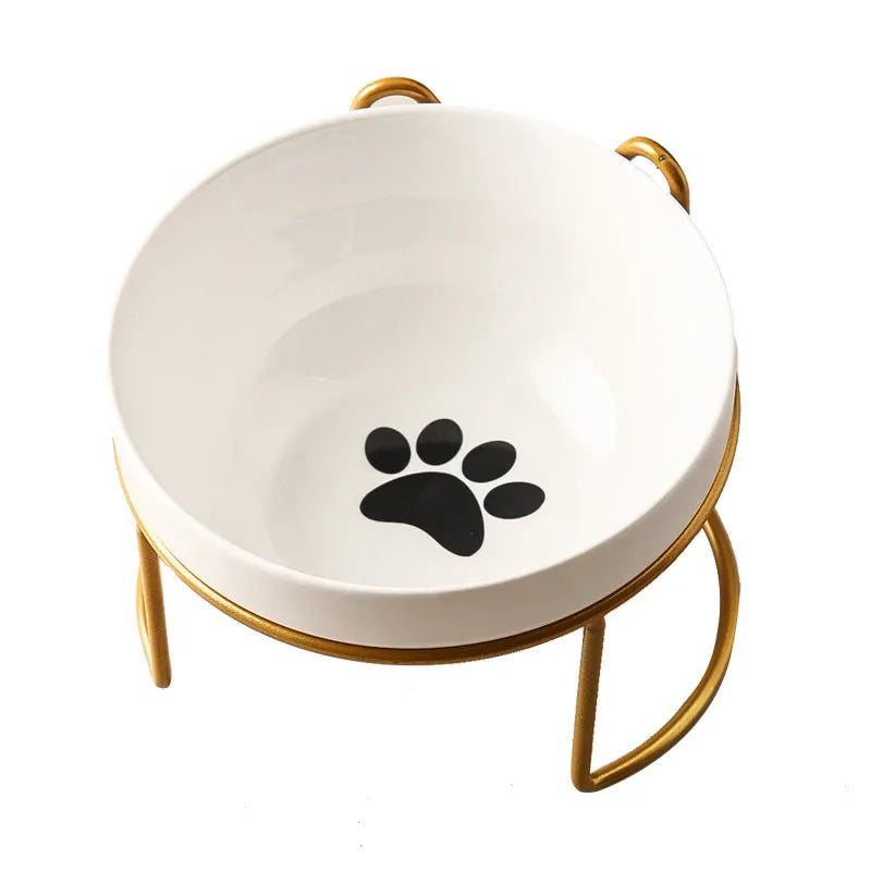 Ceramic cat bowl with iron frame stand showing cat paw print pattern and gold metal finish