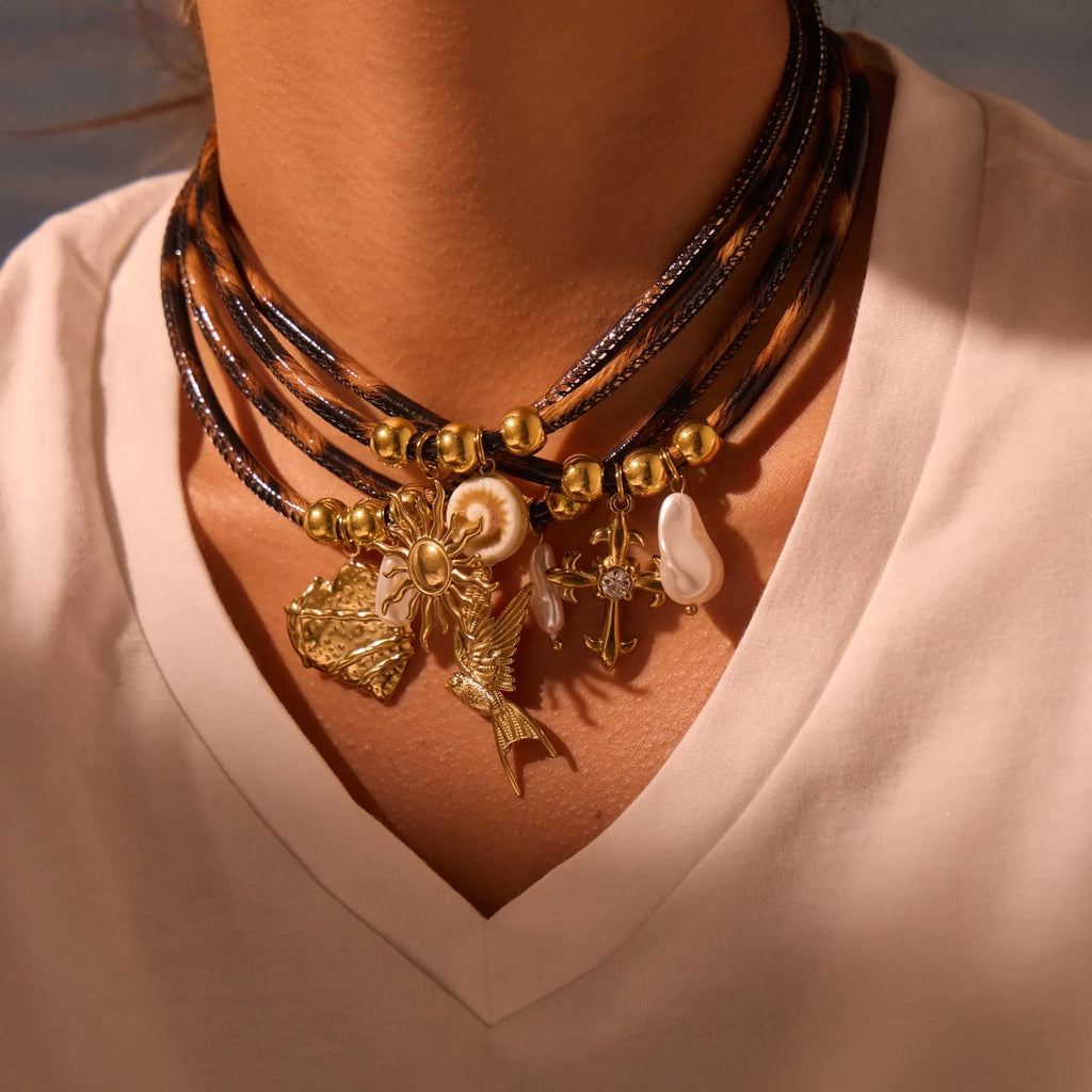 Geometric leopard print pendant on a gold-toned stainless steel necklace for women.