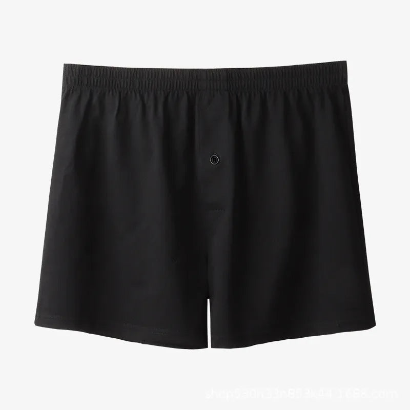 Men's solid-colour cotton boxer shorts with a high-waist, loose fit on a neutral background.