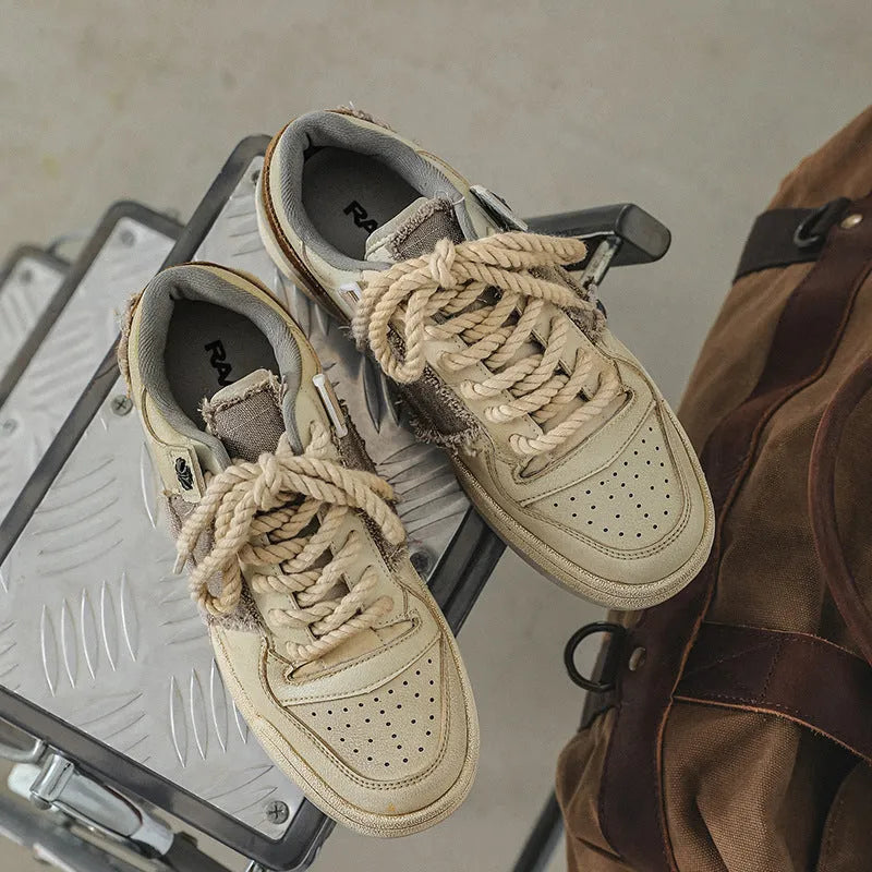 Beige low-top casual skate shoes with lace-up front and flat rubber sole.