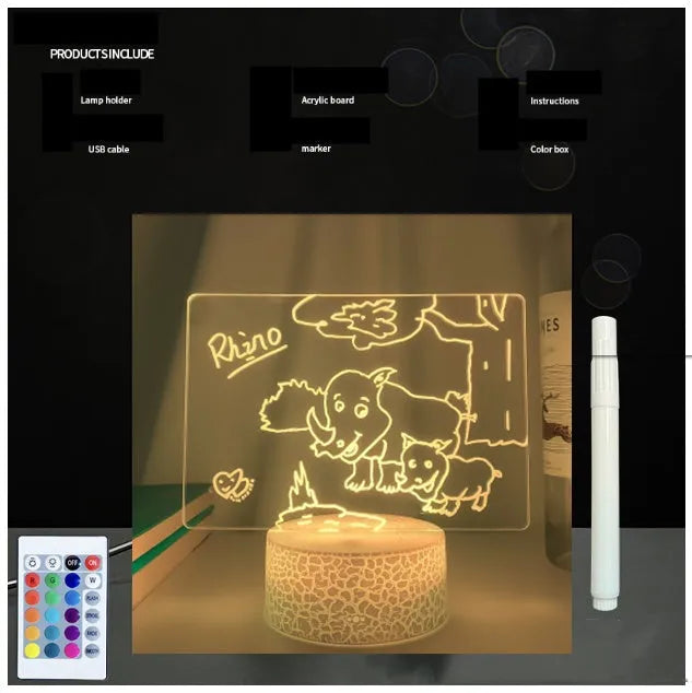 Black 3D acrylic message board LED light with remote control and marker pen on a desk.